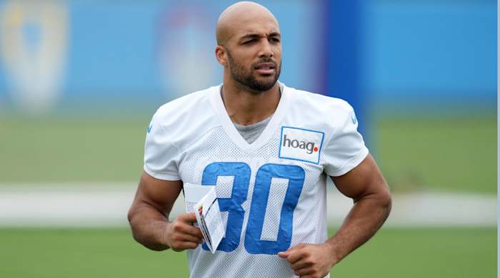 Chargers running back Austin Ekeler jogs without a helmet during practice.